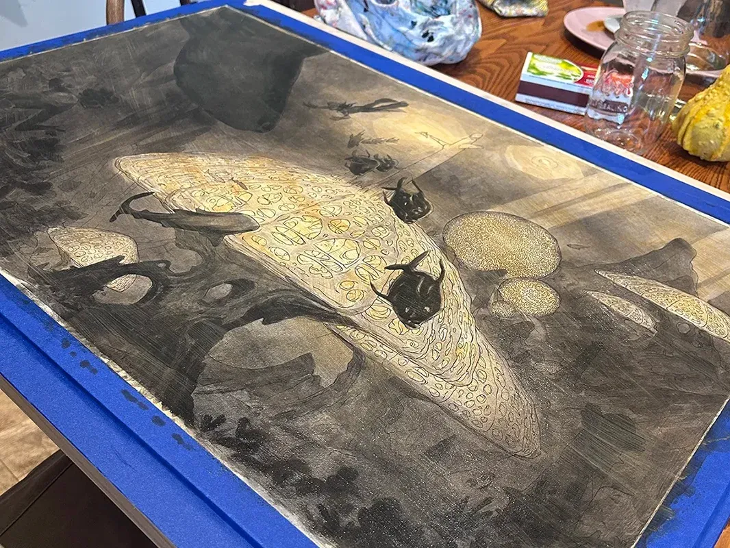 Early paint stage — black and white value block-in over the raw sienna wash.