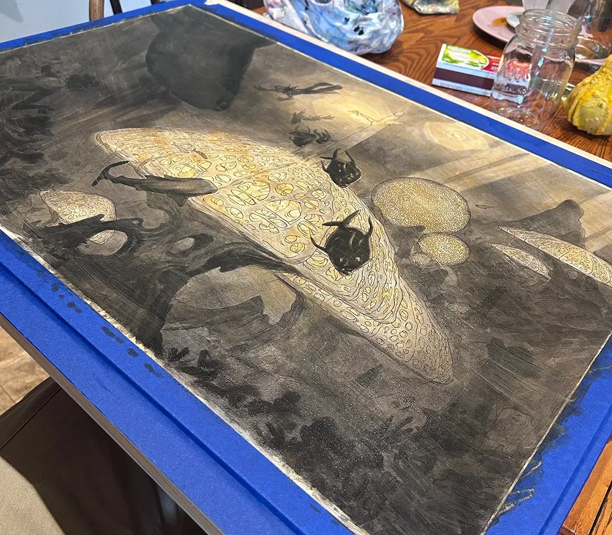 Early paint stage — black and white value block-in over the raw sienna wash.
